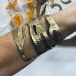 Brazalete dorado artesanal de latón, diseño abierto, hecho a mano en India, estilo boho chic.